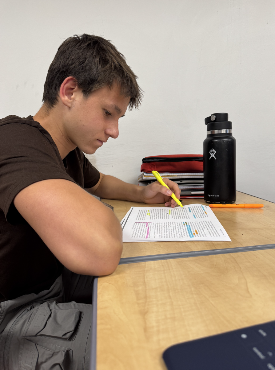 Sophomore Elliott Fisher annotates as he reads the new material on the Great Depression and Dust Bowl that was given out in his second period American Studies class. “Learning about the history of this country is very important for our education,” Fisher said. “The Great Depression was a devastating time period to our economy, and knowing how it happened will ensure it won’t happen again.”
